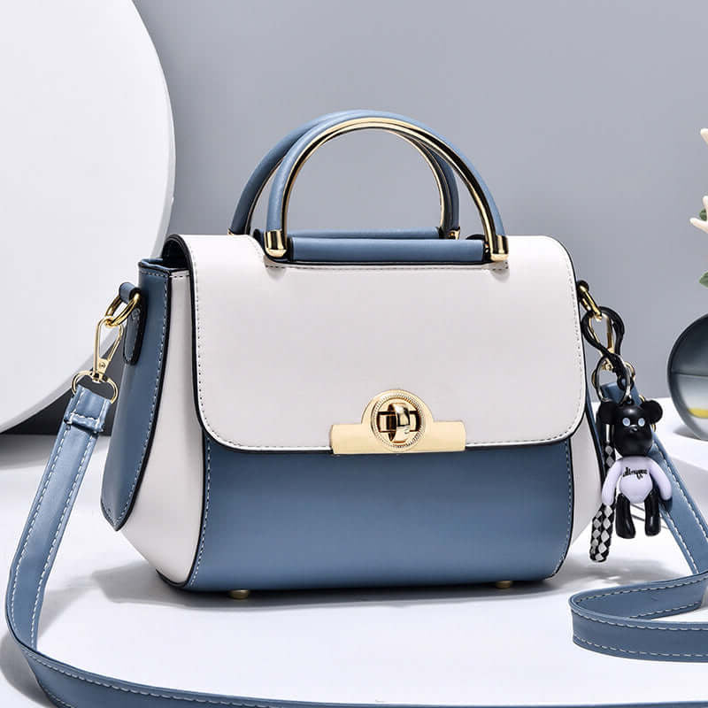 Lightweight crossbody bag with white and blue colorblock, top handle, flap, gold clasp