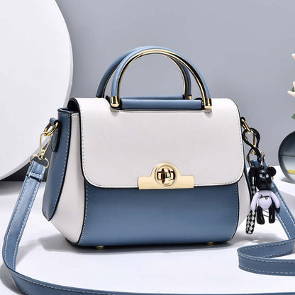 Lightweight crossbody bag with white and blue colorblock, top handle, flap, gold clasp