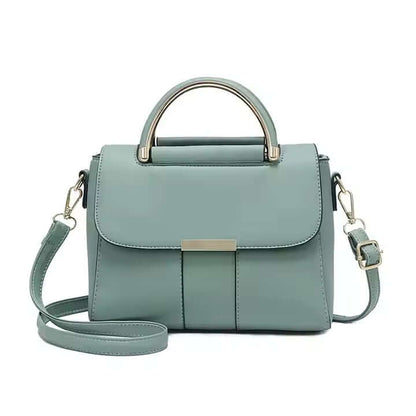 Mint green crossbody bag with curved top handle, front flap, and adjustable strap