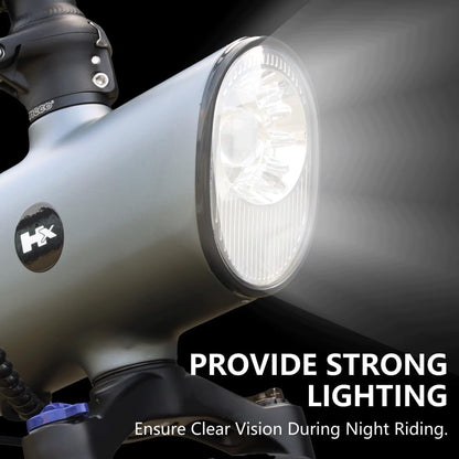Front headlight on a grey electric dirt bike with handlebar and fork visible