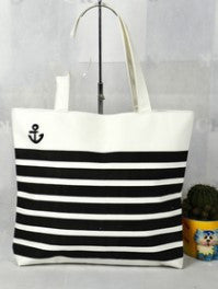White canvas tote bag with black anchor emblem and bold black horizontal stripes