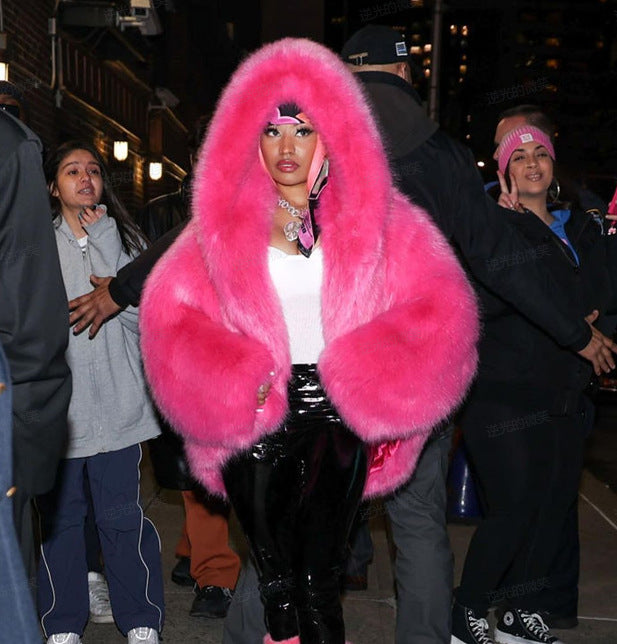 Bright pink faux fur hooded coat with oversized hood and long sleeves.