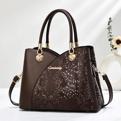 Brown stone-pattern tote bag with tan handles, gold hardware, and shoulder strap