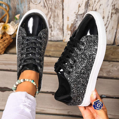 Black sequin lace-up board shoes with white rubber sole, low profile.