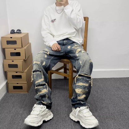 Men’s light blue ripped patch jeans with bold knee and shin patch repairs