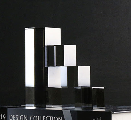 Dark smoky mirrored crystal ladder bookend with stacked step blocks, close-up
