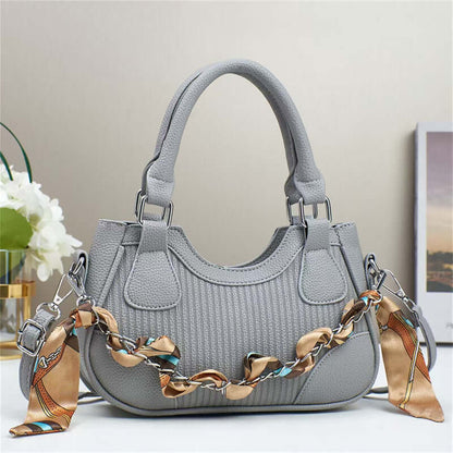 Light grey braided chain crossbody handbag with top handles and front patch pockets.