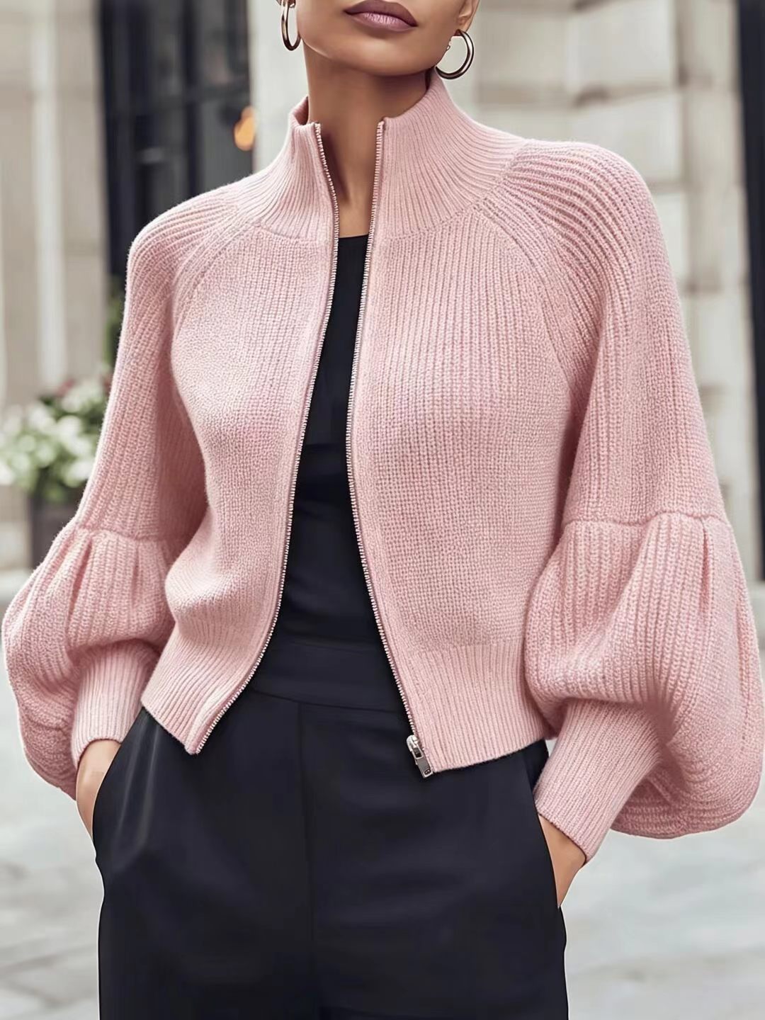 Light pink textured knit zip-front sweater with lantern sleeves and ribbed turtleneck collar
