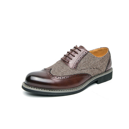 Brown leather shoe with patterned toe cap on a white background