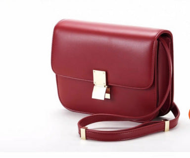 Red leather shoulder bag with front flap and gold clasp, with shoulder strap