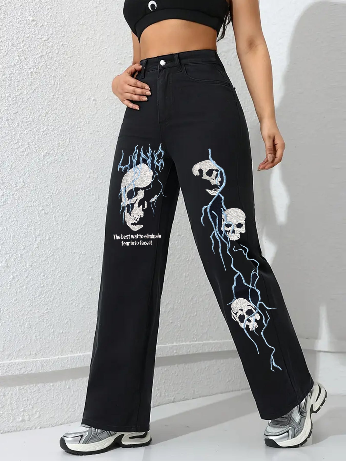 Black women’s jeans with skull and flame embroidery on straight wide legs