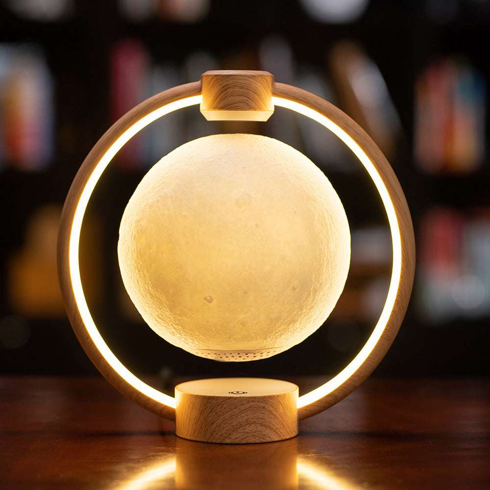 Floating moon lamp with golden glowing moon, warm LED ring, wood-toned base