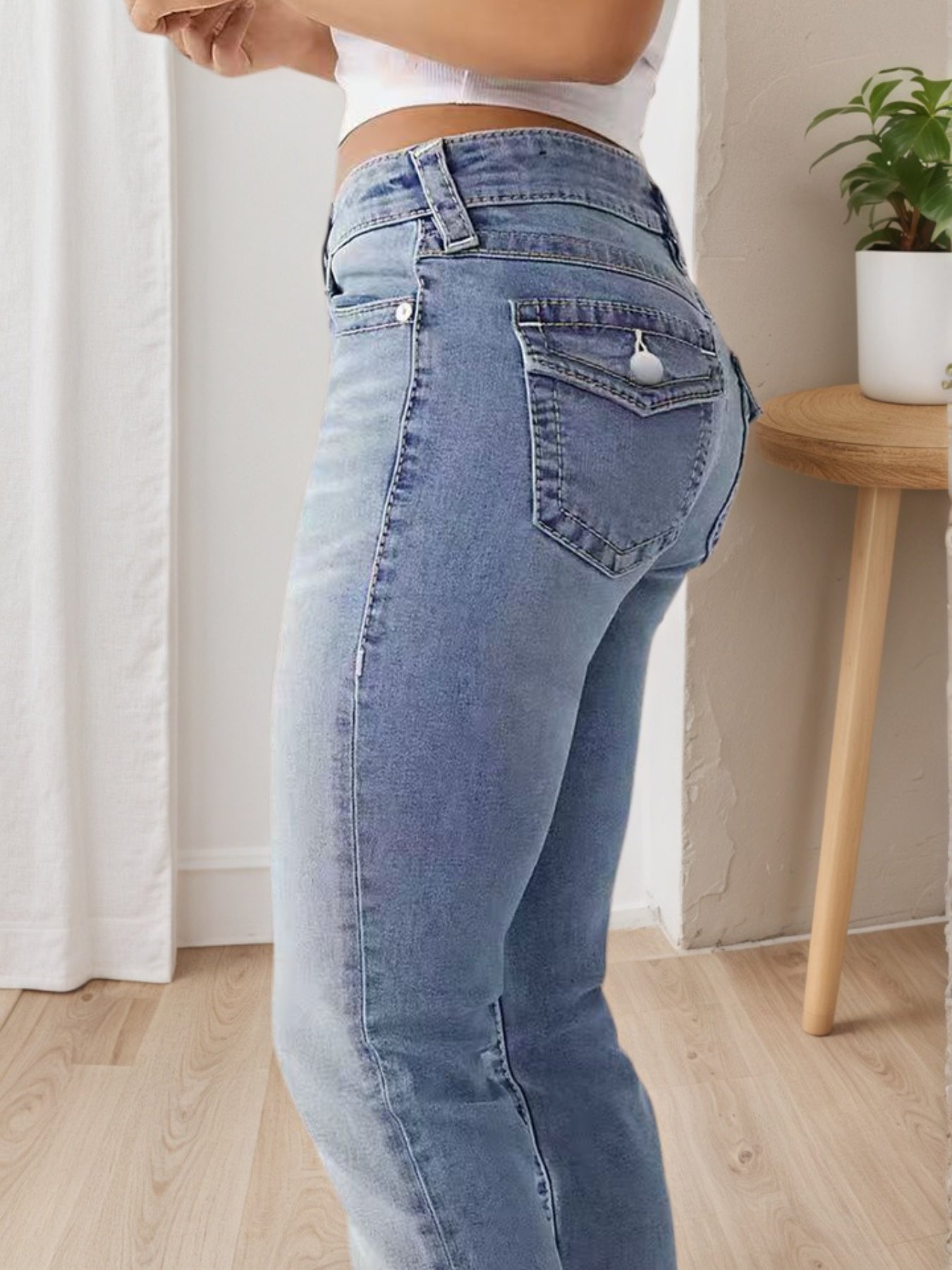 Light blue high-waisted wide-leg jeans, back pockets and belt loops visible