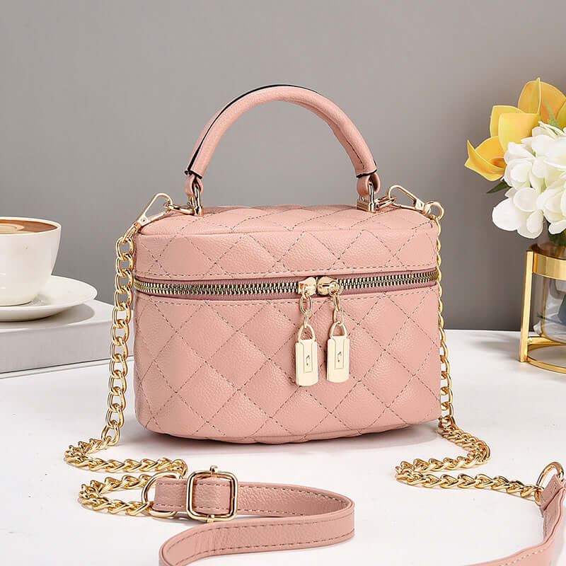 Pink quilted fashion tote with top handle, gold chain shoulder strap, double zip pulls
