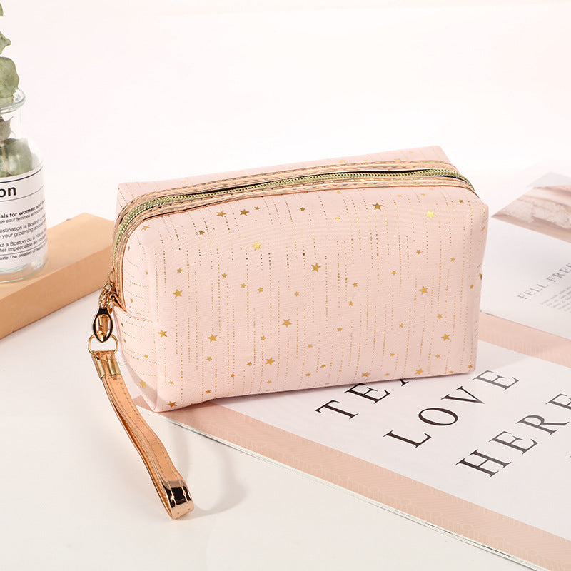 Light pink octagonal star cosmetic bag with gold zipper and wrist strap
