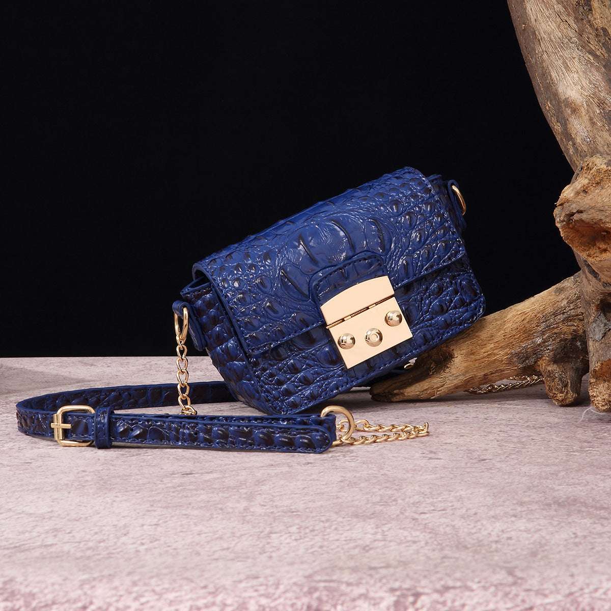 Blue croc-textured crossbody bag with flap, gold-tone lock, and chain strap