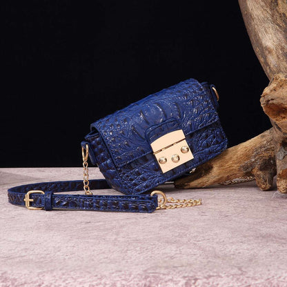 Blue croc-textured crossbody bag with flap, gold-tone lock, and chain strap