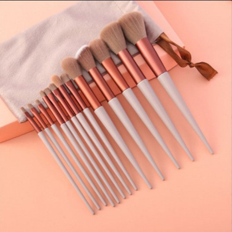 Makeup brush set with copper and silver handles and soft beige bristles