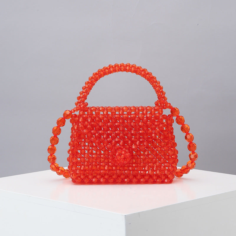 Red beaded mini tote bag with arched top handle and woven mesh bead body