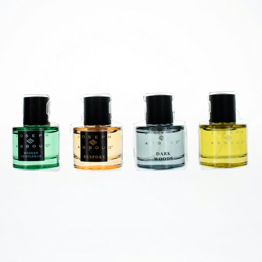 Men’s 4-piece fragrance set with four bottles in green, amber, blue, and yellow