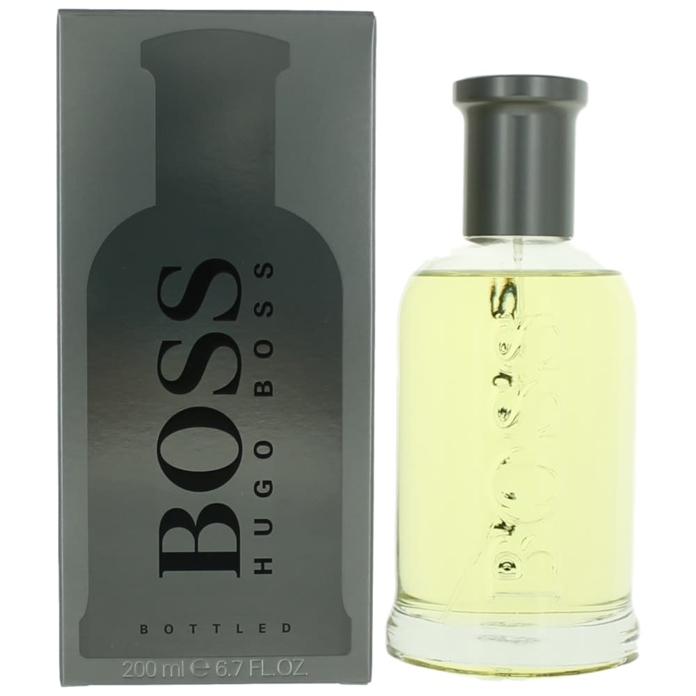 Men's eau de toilette spray bottle with clear yellow liquid and black cap, with box