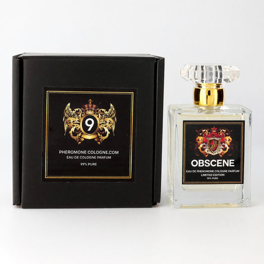 Men's cologne spray bottle with clear glass, gold cap, and black gift box