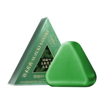 Green triangular soap with packaging on a white background