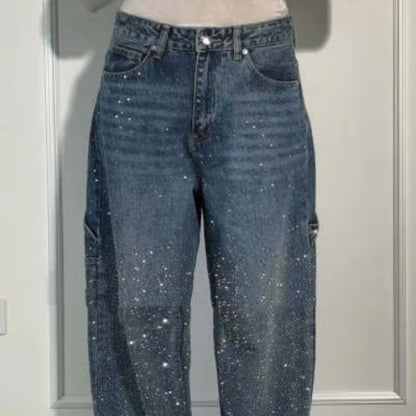 Blue jeans with glittery embellishments on a neutral background