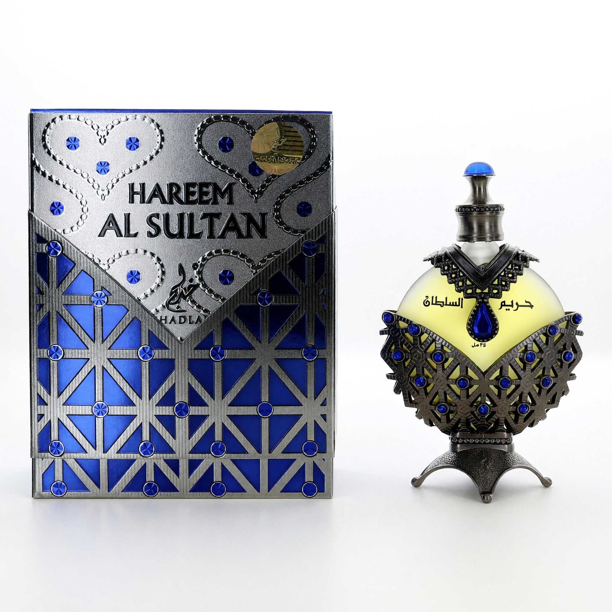 Unisex perfume oil bottle with ornate blue cap and decorative blue glass body, with box