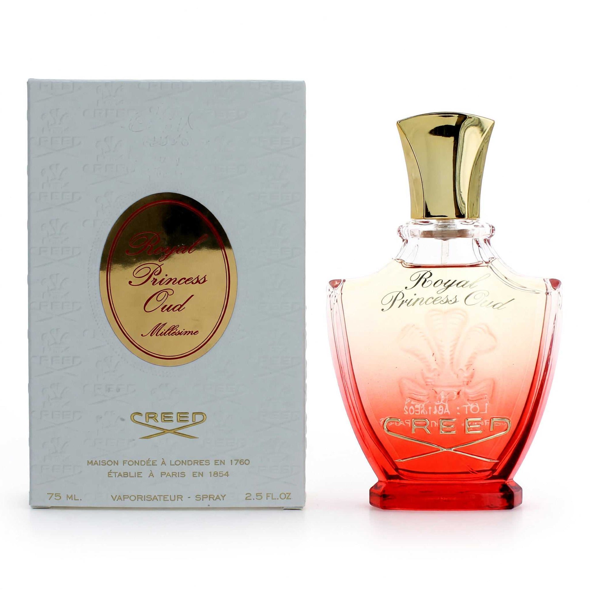 Women's oud perfume spray bottle with gold cap; pink glass, with logo box.