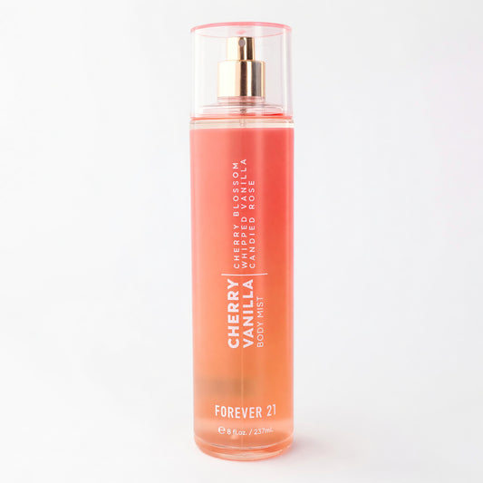 Cherry Vanilla body mist bottle with pink liquid, clear cylinder, gold spray cap.