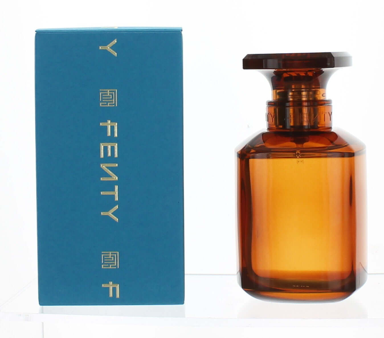Brown perfume bottle with YSL branding next to a blue box on a white background