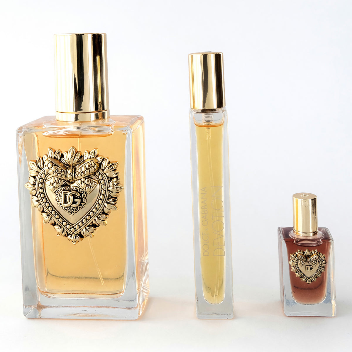 Women's 3-piece perfume gift set: three clear bottles with gold caps and heart label