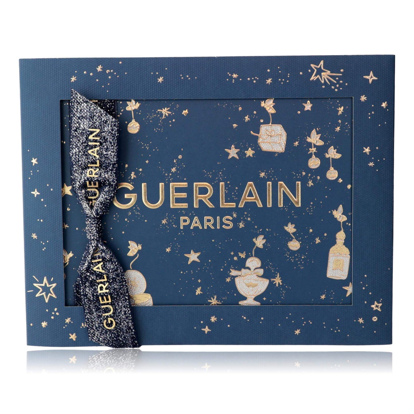 Guerlain Paris gift set box with dark blue star pattern and gold bow ribbon