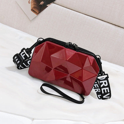 Dark red geometric mini cosmetic bag with black zipper and wrist strap