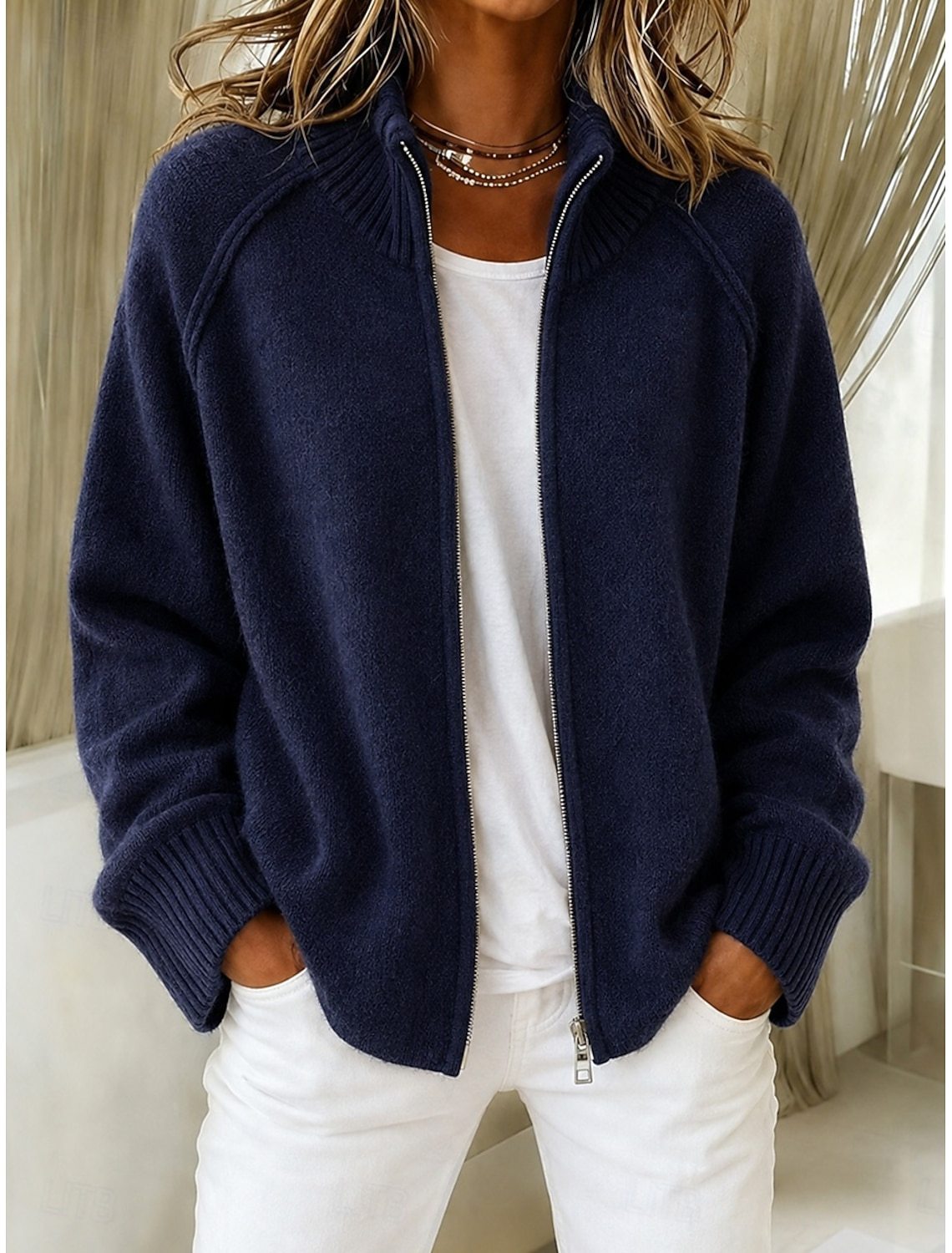 Navy knitted cardigan with stand collar and front zipper, long sleeves, ribbed cuffs