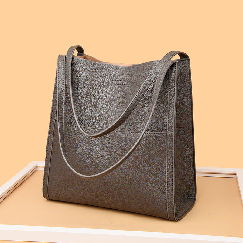 Large commuter tote bag in light gray pebbled faux leather with long shoulder strap