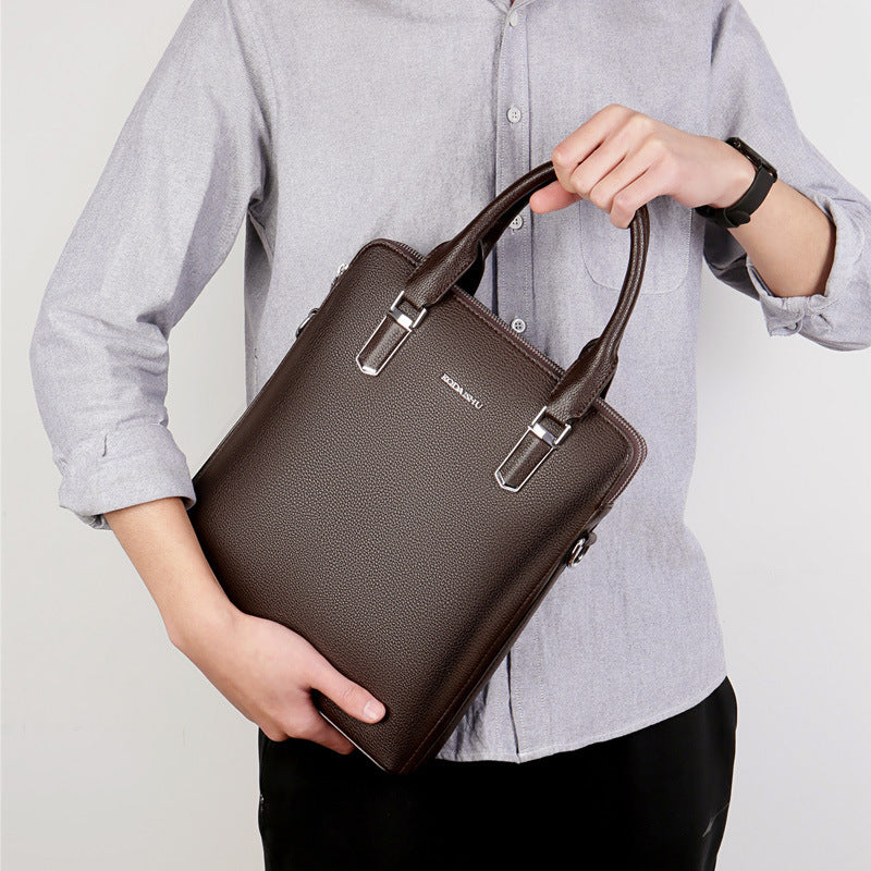 Men's brown leather computer bag with two top handles and front metal buckle