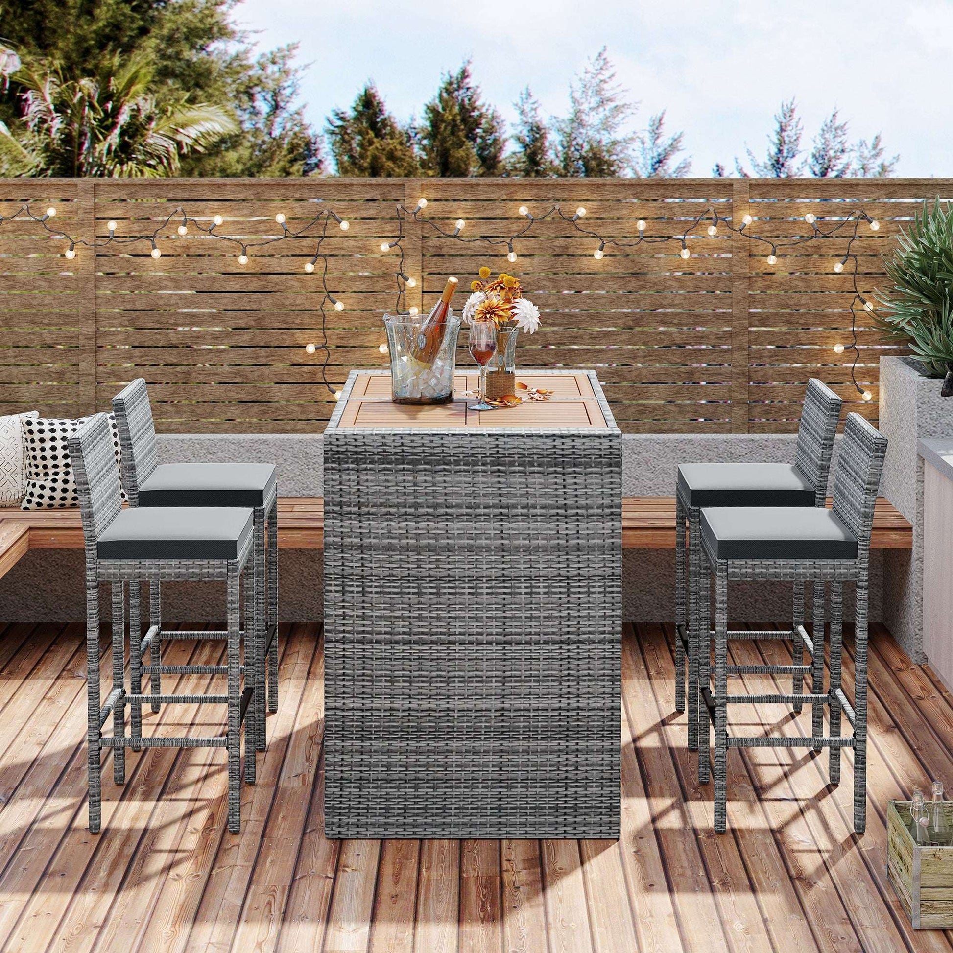 Outdoor patio wicker bar set with gray wicker bar table and four bar stools