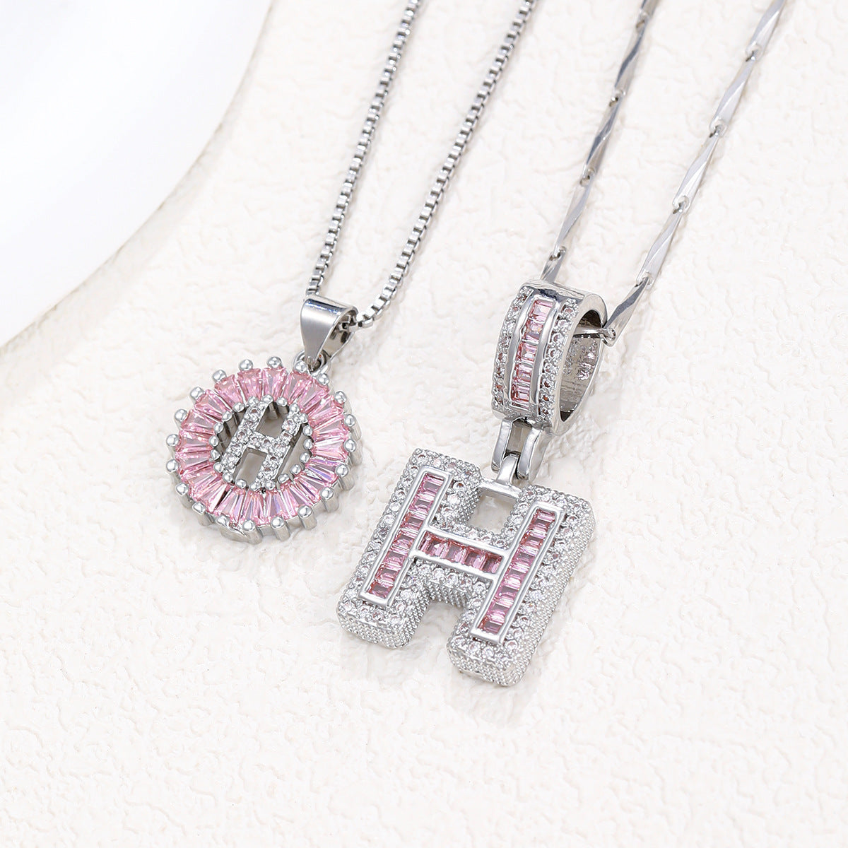 Silver pendant necklace set with pink crystal flower charm and letter charm, two chains