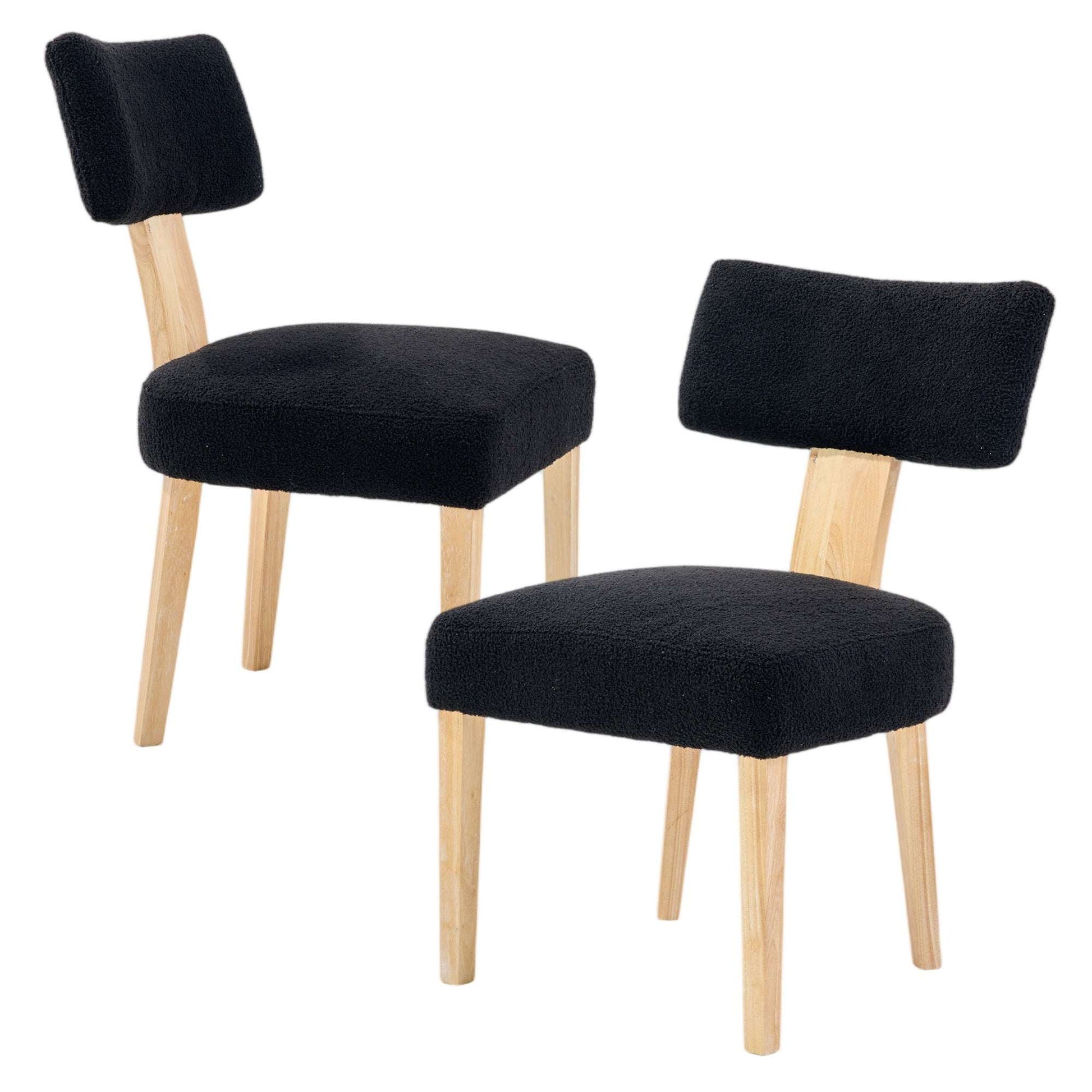 Two black upholstered dining chairs with tall backs and light wood legs