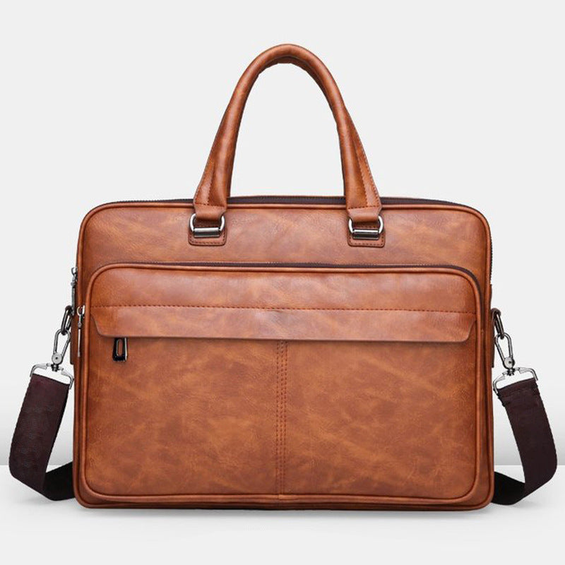 Medium brown leather briefcase with top handles, front zip pocket, and shoulder strap