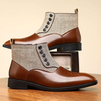 Brown leather boots with beige fabric panels on a wooden surface