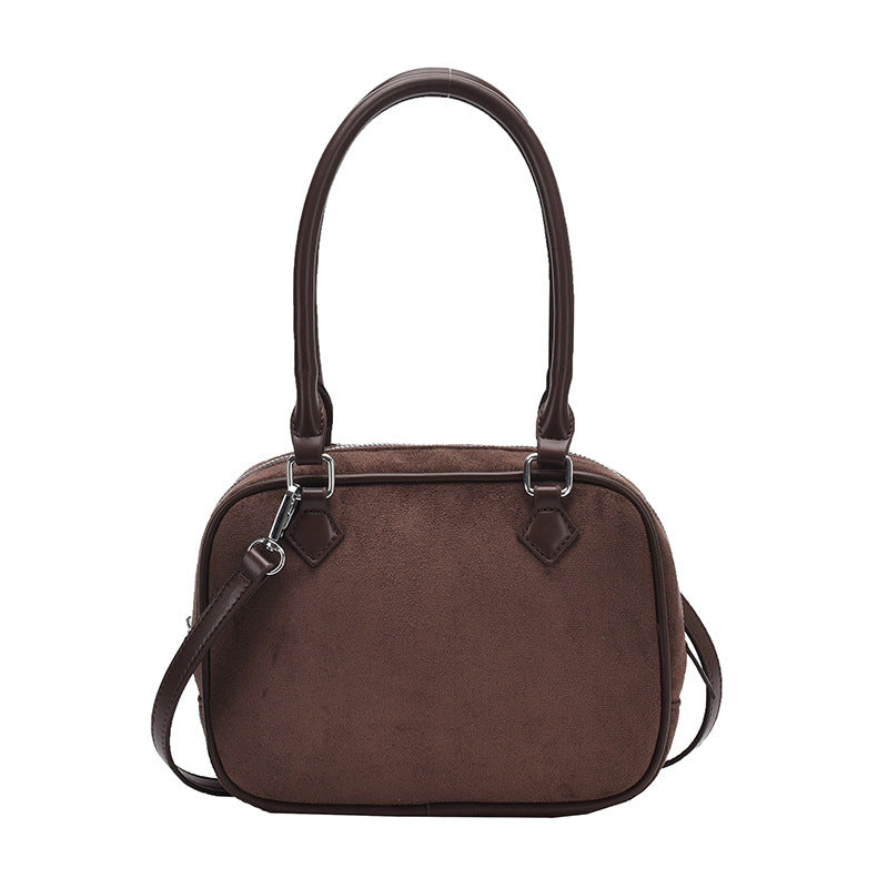 Dark brown suede crossbody handbag with top handles and adjustable shoulder strap