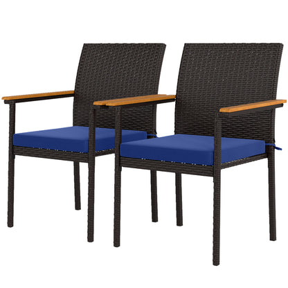 Two wicker patio dining chairs with dark frames and blue seat cushions, wood armrests