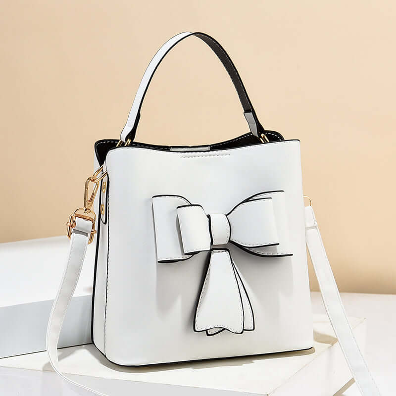 White bow bucket crossbody bag with bow front detail and adjustable shoulder strap