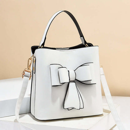 White bow bucket crossbody bag with bow front detail and adjustable shoulder strap
