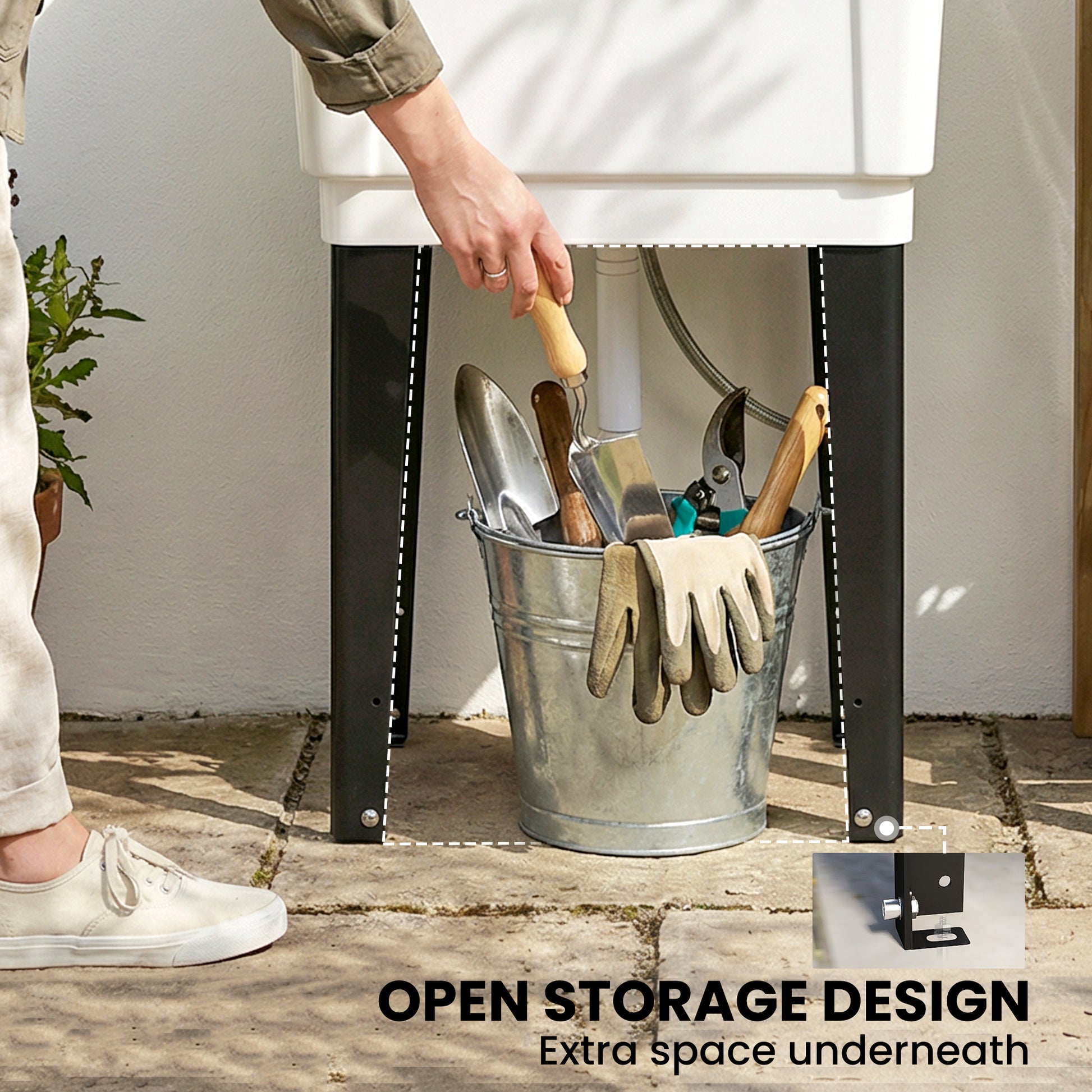 White utility sink with open under-sink storage for tools and cleaning items