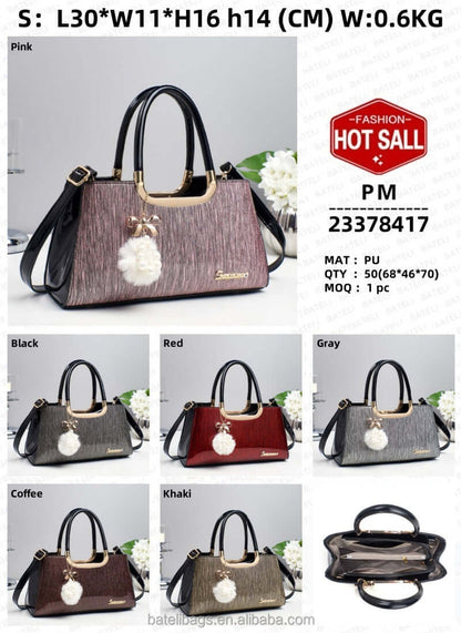 Pink glitter structured tote handbag with black handles and white pom-pom charm