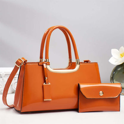 Orange hobo shoulder bag with front hanging strap detail and matching wallet pouch